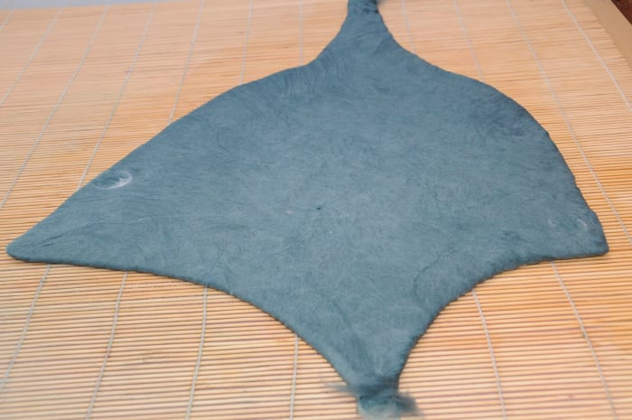 The neatened edges but leaving the fibers loose to allow for easy joining of the hat ties and adding the pixie hat tail.