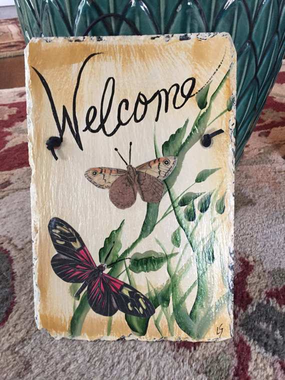You can use a mix of paint and decoupage cutouts to create a fabulous welcome slate for your home (butterflies are hard to paint, but easy to decoupage!).