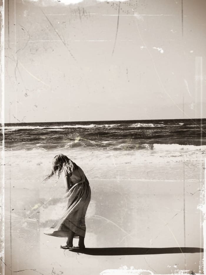 DAUGHTER This image of my daughter on the beach was changed into a sepia image. The effect was startling. The original image is bright and colorful, while this one looks nostalgic. Experimentation with imagery is always a welcome exercise.