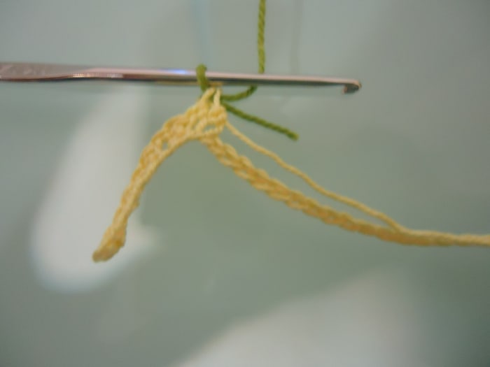 This is how it will look once you pull the new color through. From this point on, grab the new color as the working thread and continue the stitches while the old thread is hanging at the back.