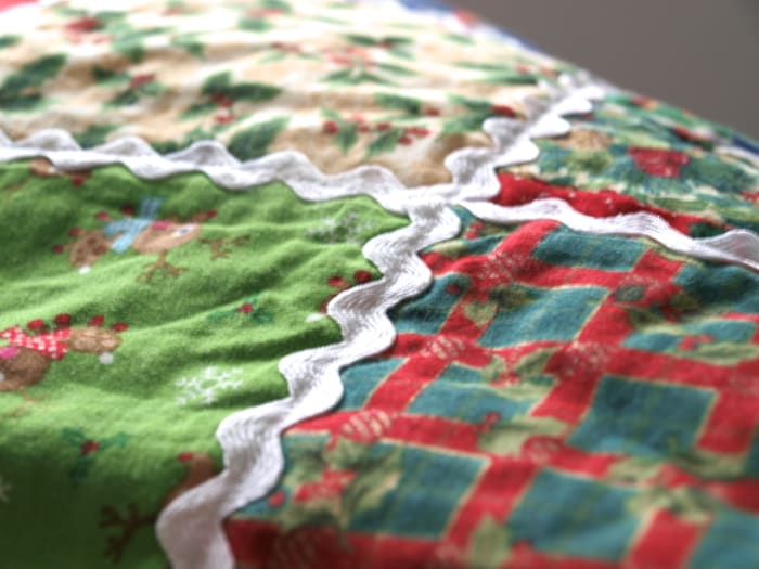 Ric Rac adds a whimsical touch to this Christmas throw quilt. It was added by machine as part of the quilting process and can be washed.