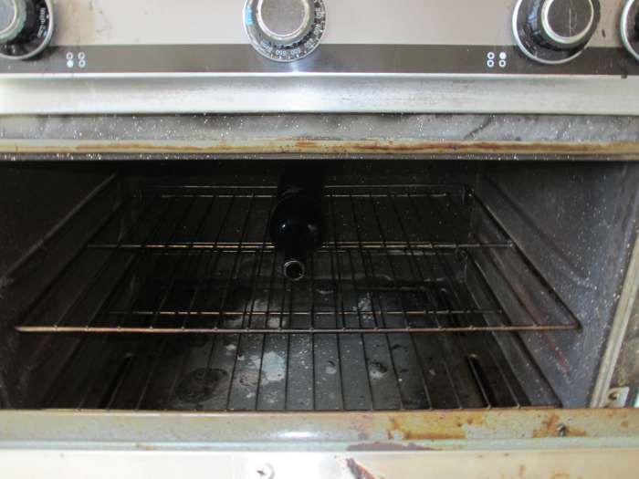 Place your wine bottles on the oven rack. (Pardon my ancient, stained oven. It's older than I am, but it still works beautifully.)