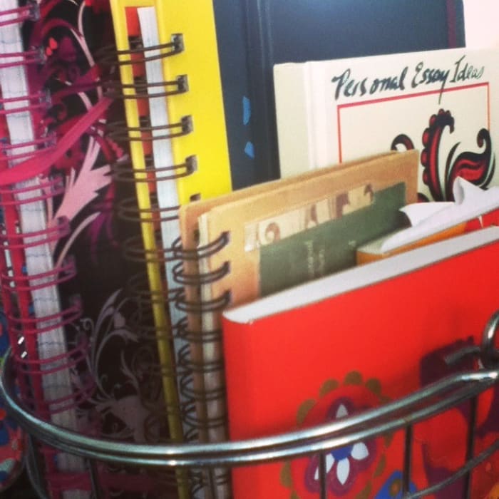 Use a wire basket or decoratove box to keep your mismatched and odd-shaped journals in plain sight where you're more likely to pick them up and start writing in them!