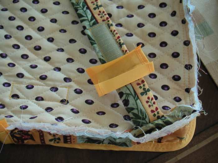There was no way to enclose both sides of fabric around this strap without adding another piece of bias tape.