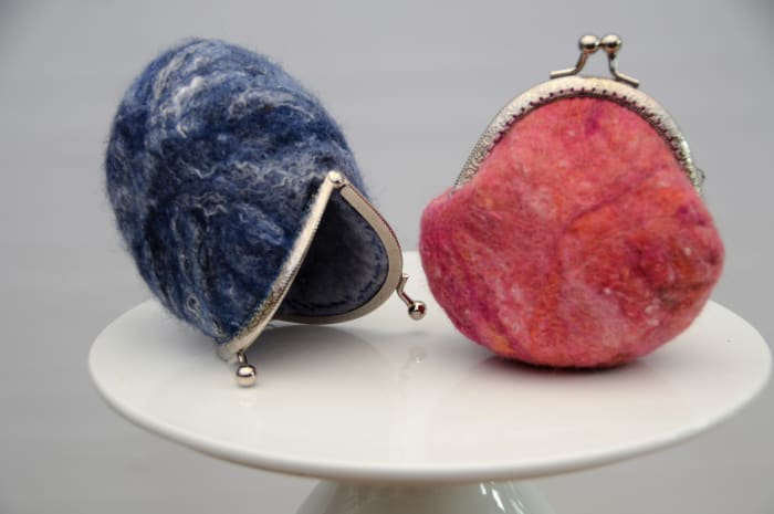 The blue purse shows some of the texture and shine obtained from the Botany Lap Waste fibers.
