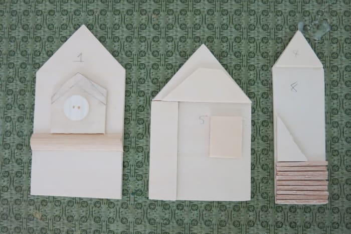 Adding pieces of scrap wood creates some architectural detail to each building on my sign.