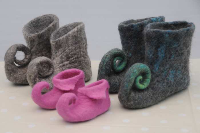 A group of Wet Felted Pixie Slippers. The larger pairs of slippers were made with 3 layers of wool on both sides. The pink pair were made using 2 layers of wool.