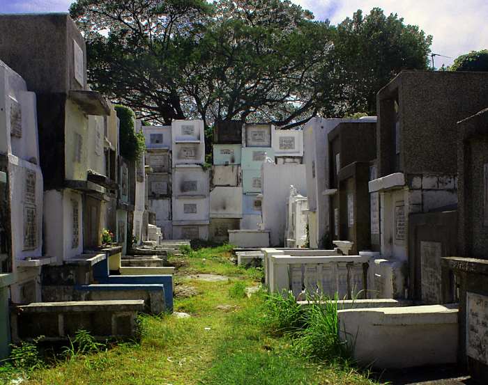 Filipino cemeteries like this one in Santa Rosa, Calabarzon fill with revelers bearing candles and flowers to honor their deceased loved ones on All Saints' Day.