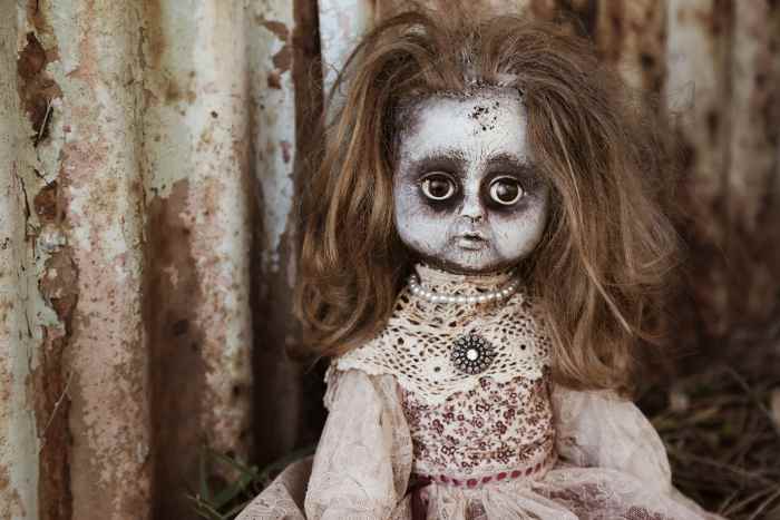 Add some spooky-looking dolls: Use makeup, paint, flour, etc. to turn a regular doll into a zombie doll.