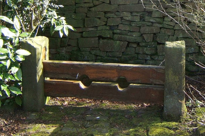 Old Stocks at Chapeltown, Lancashire, UK. The prisoner was required to kneel or lie down, face up or face down, in these stocks.