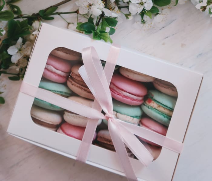 Macarons, chocolates, or other nicely packaged food items make for a nice Christmas gift that won't go to waste.