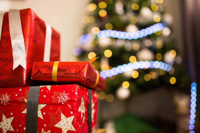 Use a different color ribbon for each person, and don't tell them whose is whose until Christmas Day.