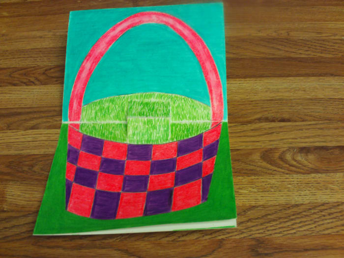 Here I have completed coloring in the basket with the pink and purple colored pencils.