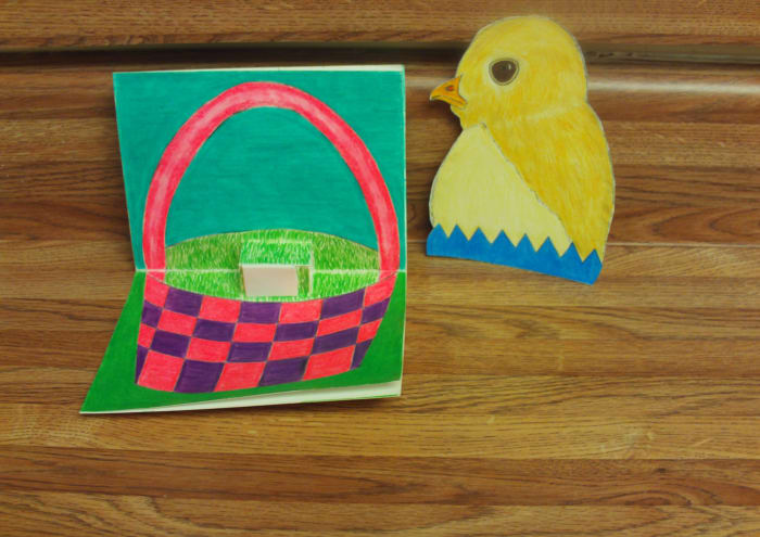 Here I have adhere a foam adhesive to the pop-up portion of the card. I am now ready to attach the baby chick to the pop-up.