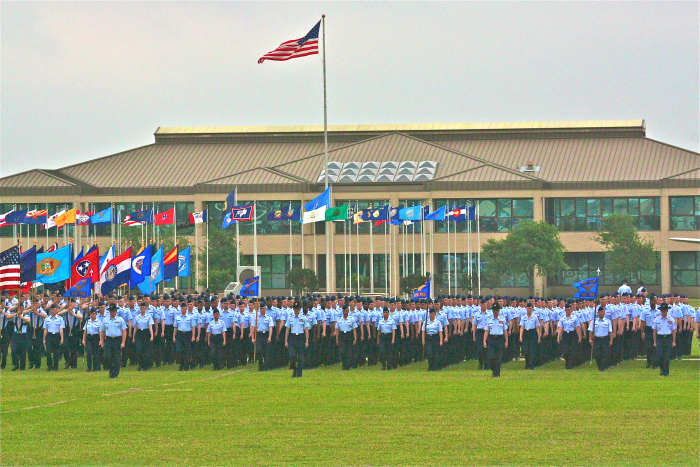 The US flag is on the tallest staff, and is carried in front of state flags by the standard bearers on foot.