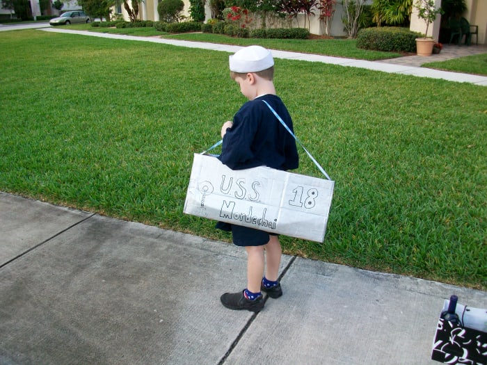 Complete the boat costume with a sailor hat and navy t-shirt, or other nautical accessories you may have around the house.
