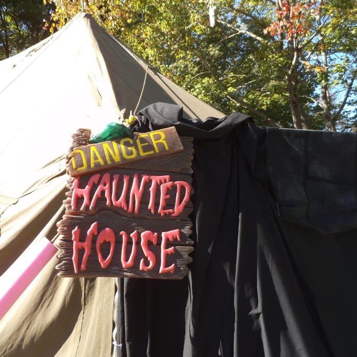 Here they've draped black sheets and painter's drop cloths to enclose part of the porch. The sign is one you could make with paint and boards you have around. I sure would be hesitant to enter.