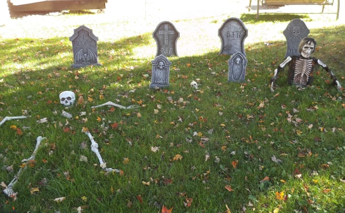 As visitors approach your spooky porch, set the atmosphere with some yard decor. A graveyard is a natural for this. I took the photo on a sunny day, but in the evening, this takes on a creepy look.