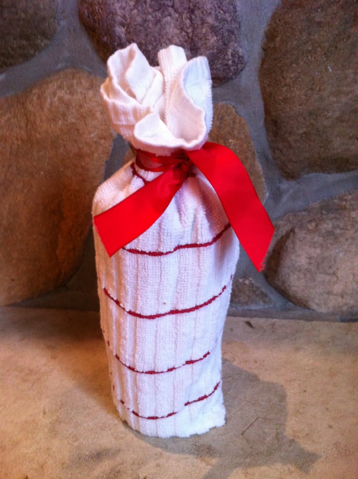 Wrap your gift in something that the recipient can use, like a hand towel or dish towel.