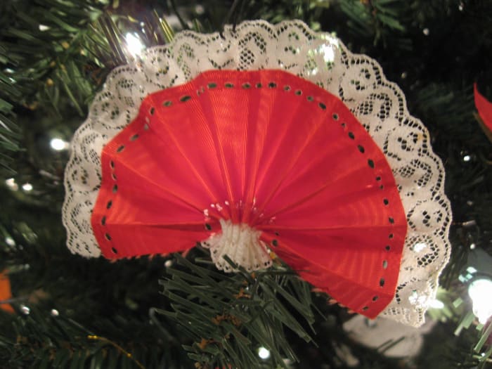 You can make these ornaments by pleating ribbon and stitching it at the bottom for a fan shape. Make some with blue ribbon, red ribbon, and ribbon with stars on them.