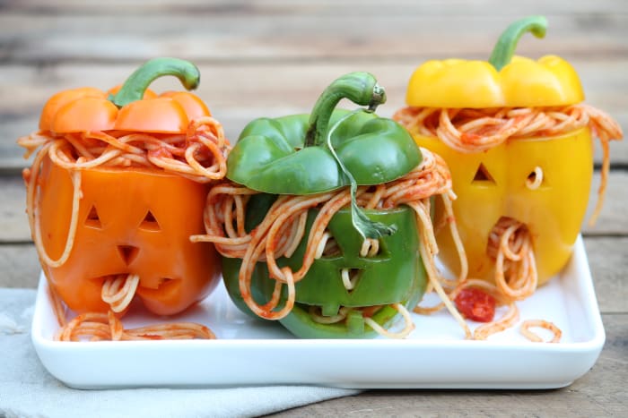 Scare your way into the hearts of friends and family by surprising them with stuffed Jack-o-Lantern peppers.