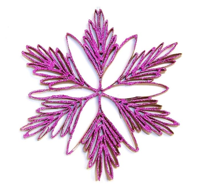 Put toilet paper rolls to work to create these glittery snowflake ornaments that are sure to brighten up your Christmas tree.