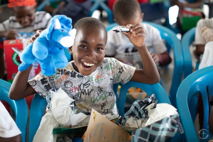 A boy in Botswana proves that a well-made stuffed animal is a guaranteed shoebox hit regardless of age or gender.