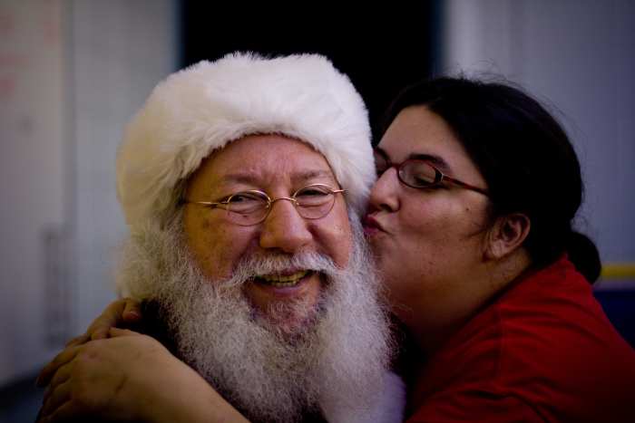 Santa gets some sugar. After putting up with frightened and cranky toddlers and long lines at the mall, Santa deserves a little loving, don't you think?