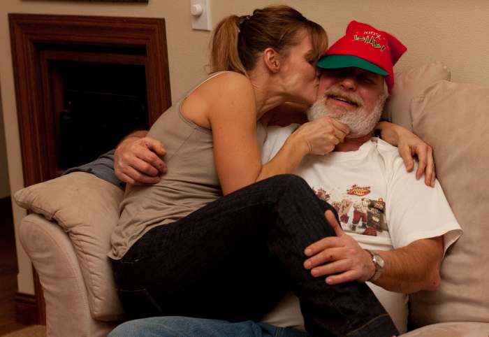 That doesn't look like Mrs. Claus to me, Santa! (Santa's not resisting too much.)