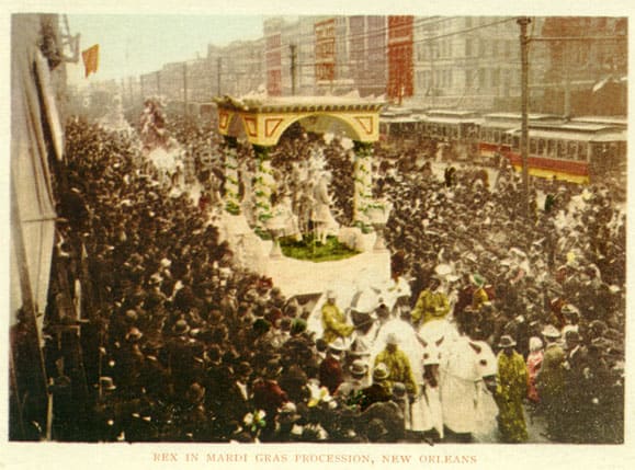 This postcard view (approx. 1900) shows a horse-drawn Rex parade float moving down a crowded Canal street.