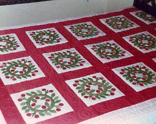 When I was president of the Baltimore Heritage Quilt Guild, they made this applique quilt to raffle off as a fundraiser. I love the designs and colors which are perfect to display at Christmas.