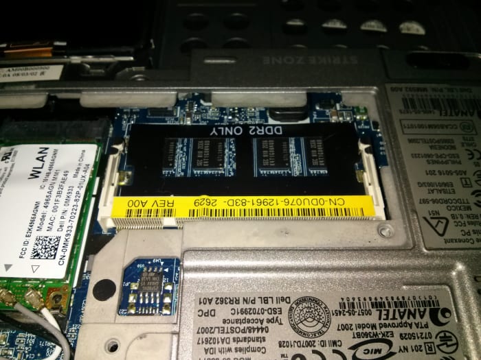 The panel removed, exposing the RAM slot and showing the 1 GB of RAM that is soldered to the motherboard already.