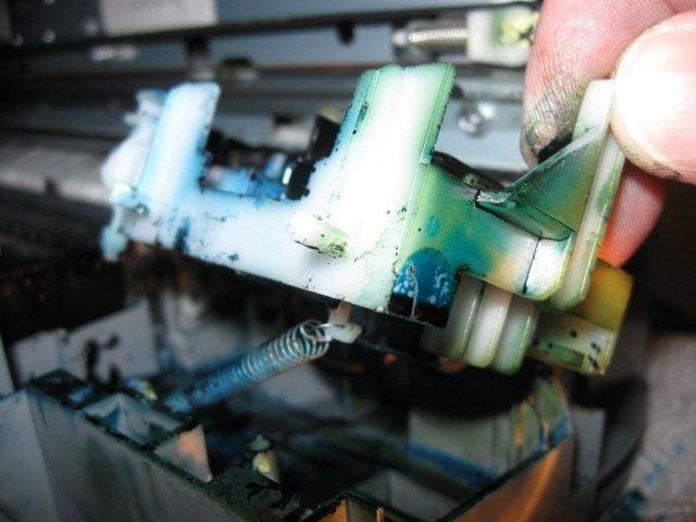 You can carefully lift the cap-blade unit out of its tray. There is a spring that holds the unit to the left when in place. Carefully unhook the spring