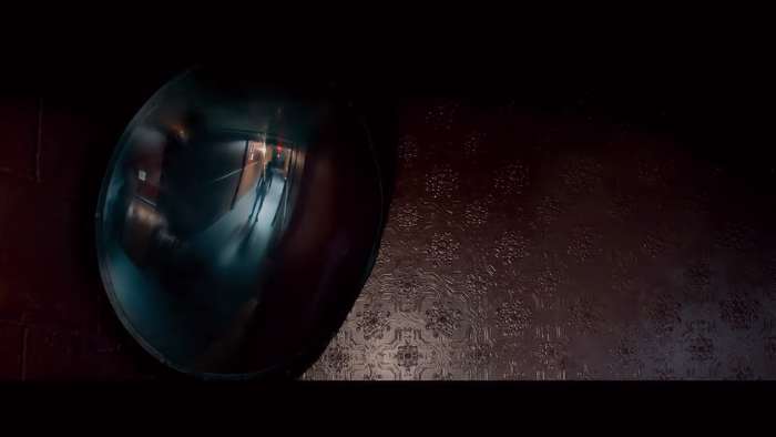 A figure appears in a hallway security mirror inside the Tilden Morgue. 'The Autopsy of Jane Doe' (2016)