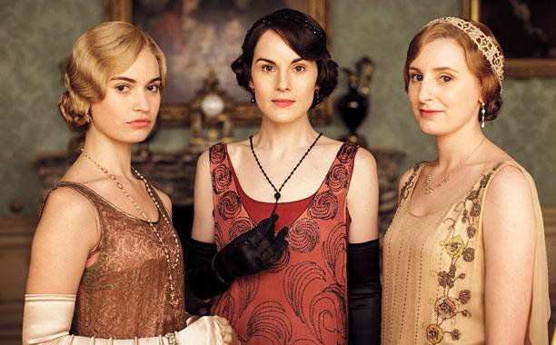 Lily James, Michelle Dockery, and Laura Carmichael as Rose MacClare, Mary Crawley, and Edith Crawley.