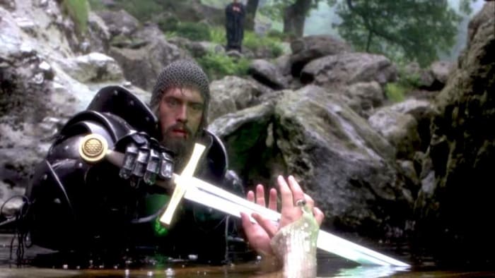 King Arthur (Nigel Terry) reaches for the mended Excalibur from the Lady of the Lake (Hilary Joyalle)