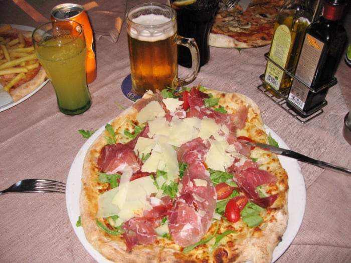 Italian Pizzerias offer a rich menu with several pages of topping choices. One pizza is served for each person - the crust is much thinner and lighter than American pizza.