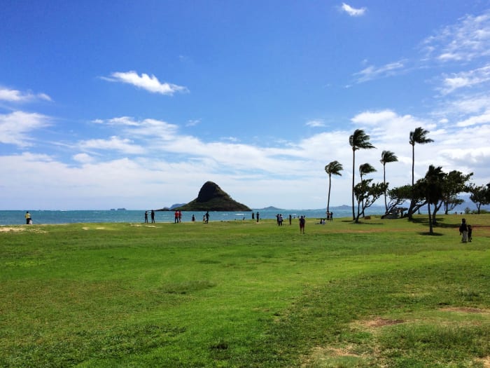 Kualoa Beach Park is a serene rest-stop with picnic tables and bathrooms. You will have a full view of Mokoli'i, also known as Chinaman's Hat, an offshore islet.