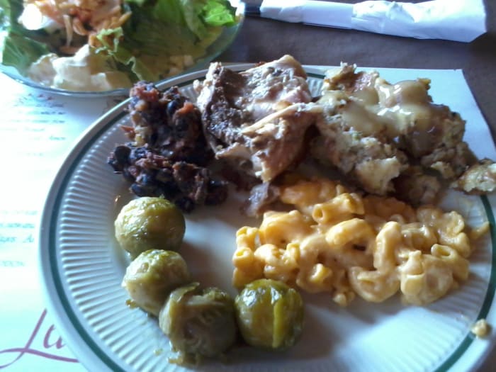 A dainty and delicious salad; Brussels sprouts, real mac and cheese, stuffing with chicken gravy, roasted chicken, and black bean and sausage stew
