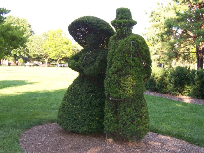 These two topiaries are a part of the whole that recreate a painting of a landscape at this park.