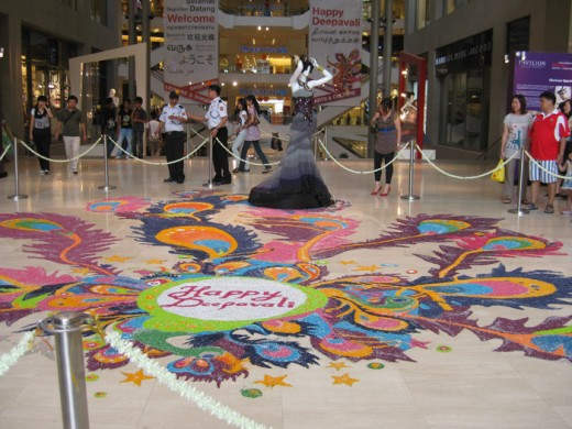 A Deepavali (Indian "Christmas") rice decoration on the floor at the entrance to the Pavilion shopping complex. © 2010 Suzanne Day