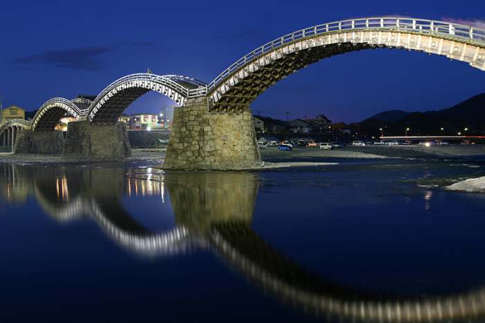 Kintai Bridge displays fine traditional Japanese wood craft. The nighttime illumination combined with the reflection from the river leave a lasting impression.