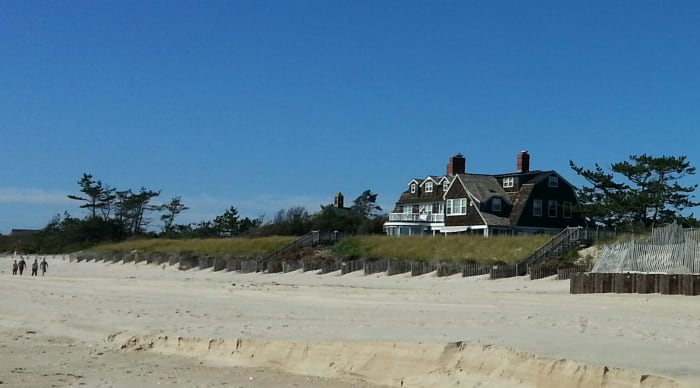 The Saltbox style house, a staple of American colonial architecture, features a steeply sloping roof which tapers down from two stories to one.
