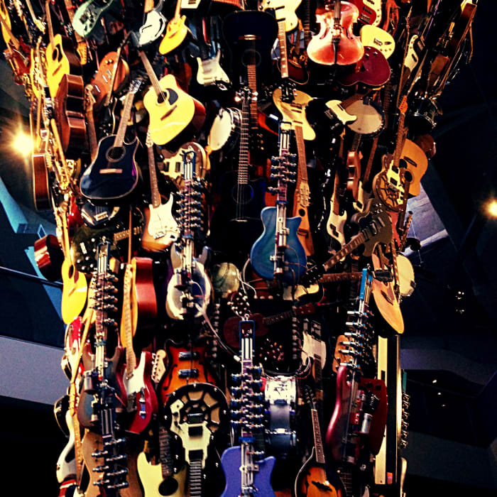 The guitar sculpture hanging from the ceiling of the EMP museum in Seattle, Washington. I cannot begin to count how many instruments make up this amazing art piece.