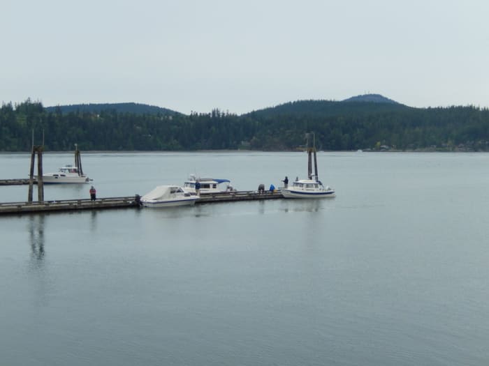 Small boats at floating docks in Cornet Bay, Whidbey Island, Wa. Boats and owners can stay overnight here or just stop to secure gear before crossing to Friday Harbor.