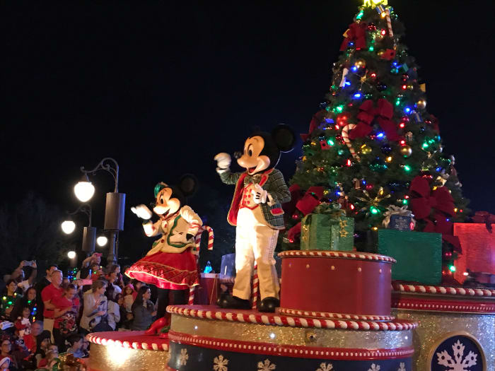 Mickey and Minnie Mouse waving from their float during the parade at Mickey's Very Merry Christmas Party