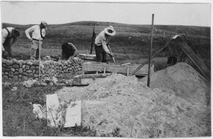 CCC workers building a rock wall