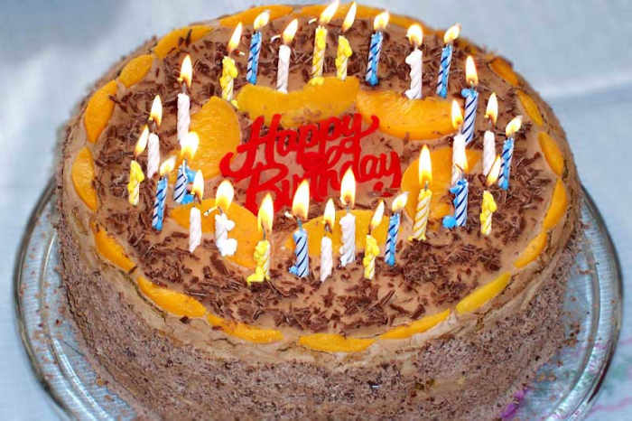 Where does the tradition of blowing out the candles on a birthday cake in one breath come from?