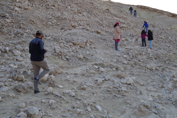 Some members of the entourage climbing up the barren and rocky hill (December 2015).