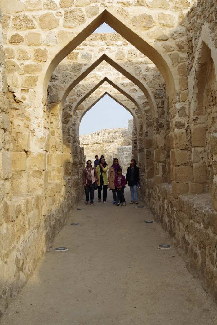 Women and children of our entourage walking under the arches supporting the roof of the fort (December 2015).
